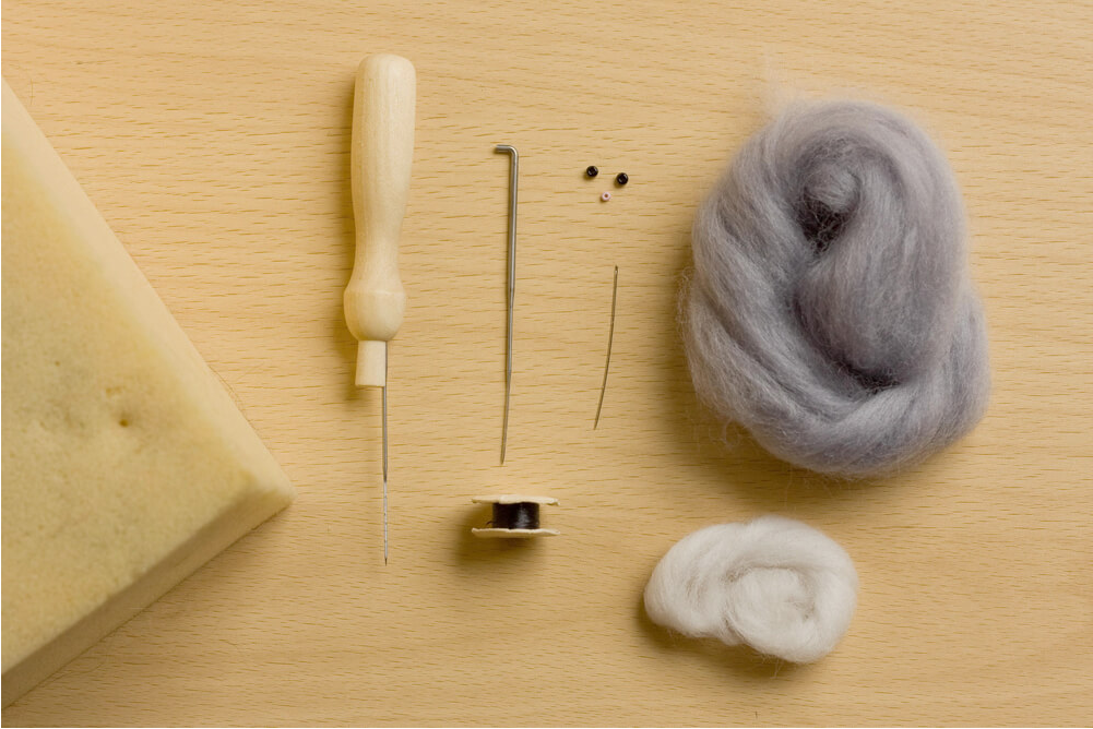 Materials and tools used for making pet felt portraits.